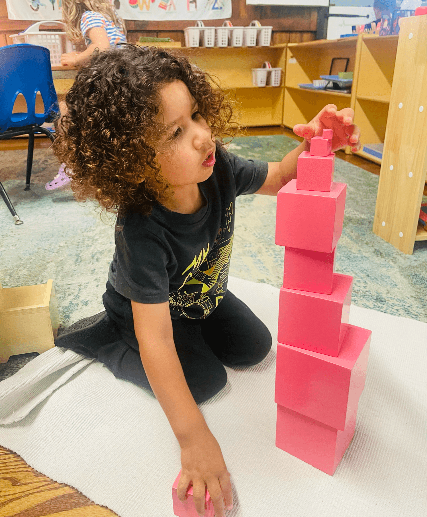 Child concentrating on pink tower activity